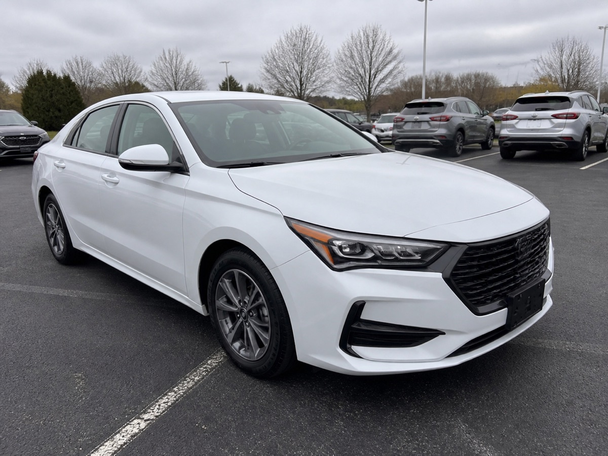 White sedan photographed in an outdoor parking lot